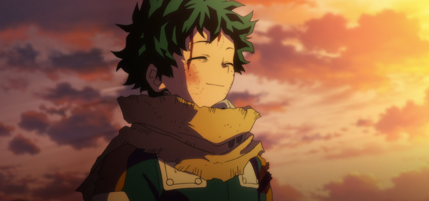 Deku smiles into the sunset. His cheek facing the camera has a red spot